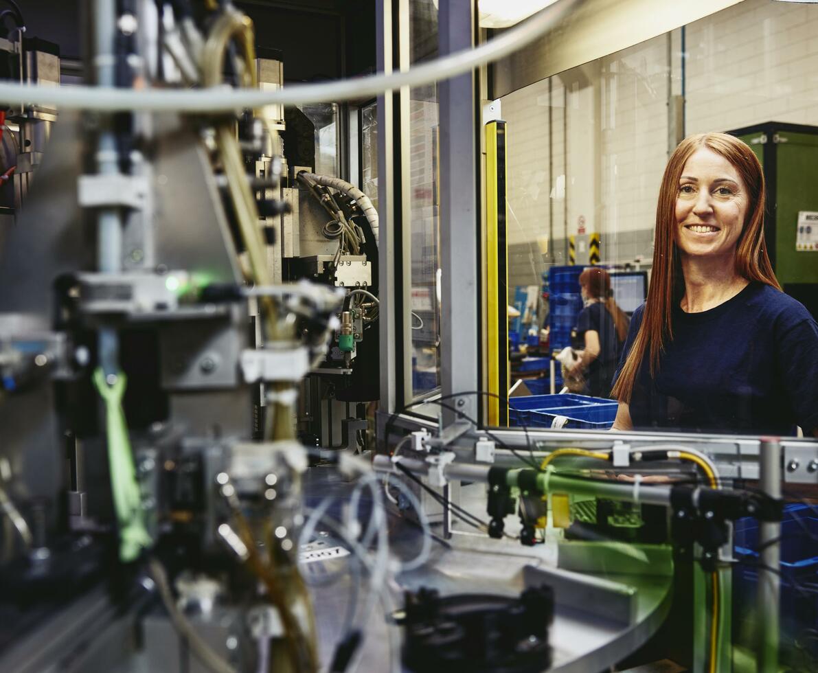 Woman operating a machine on a production site. 