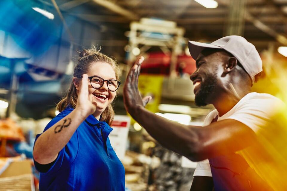 man and woman giving a high 5