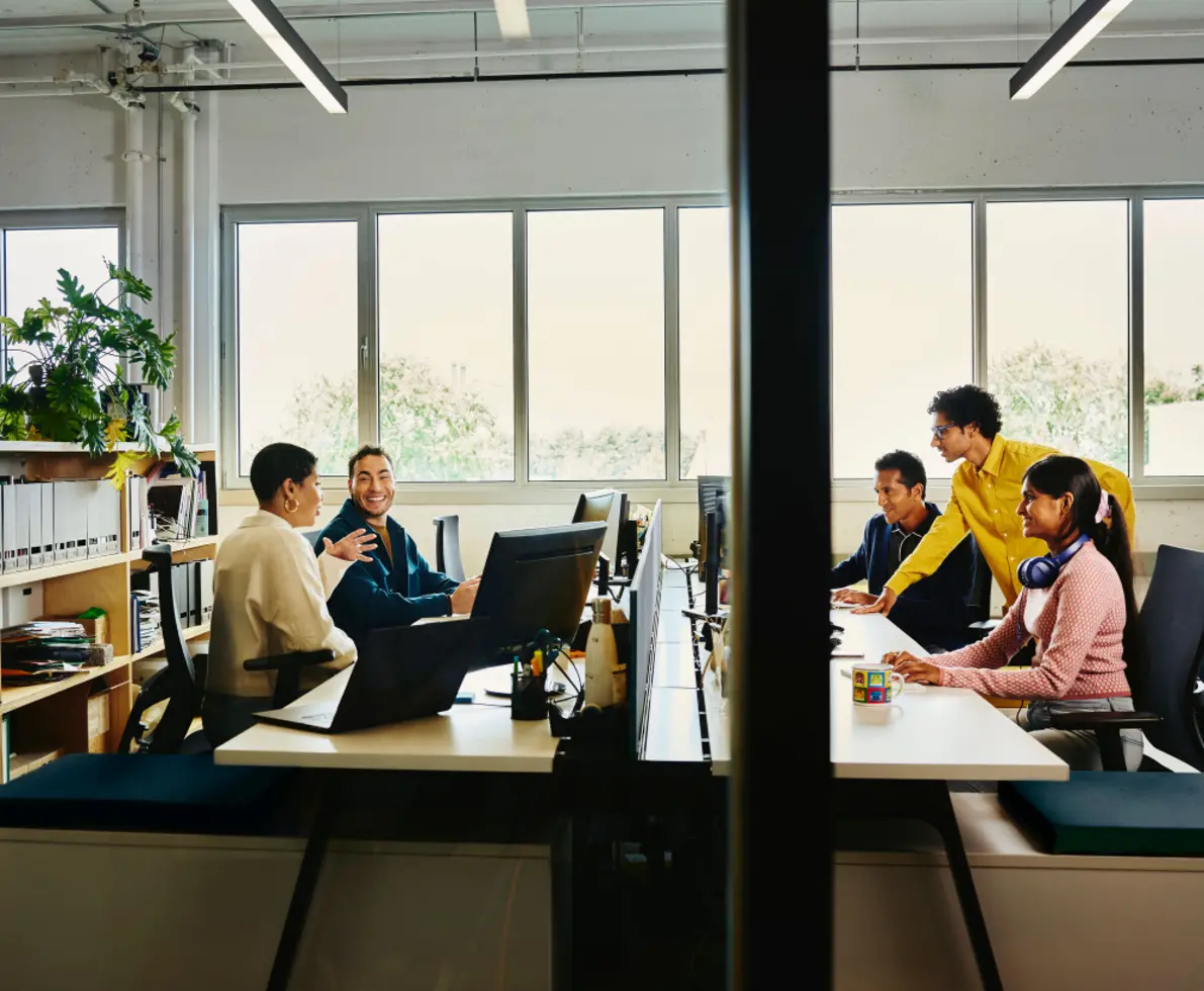 a group of people discussing in an office